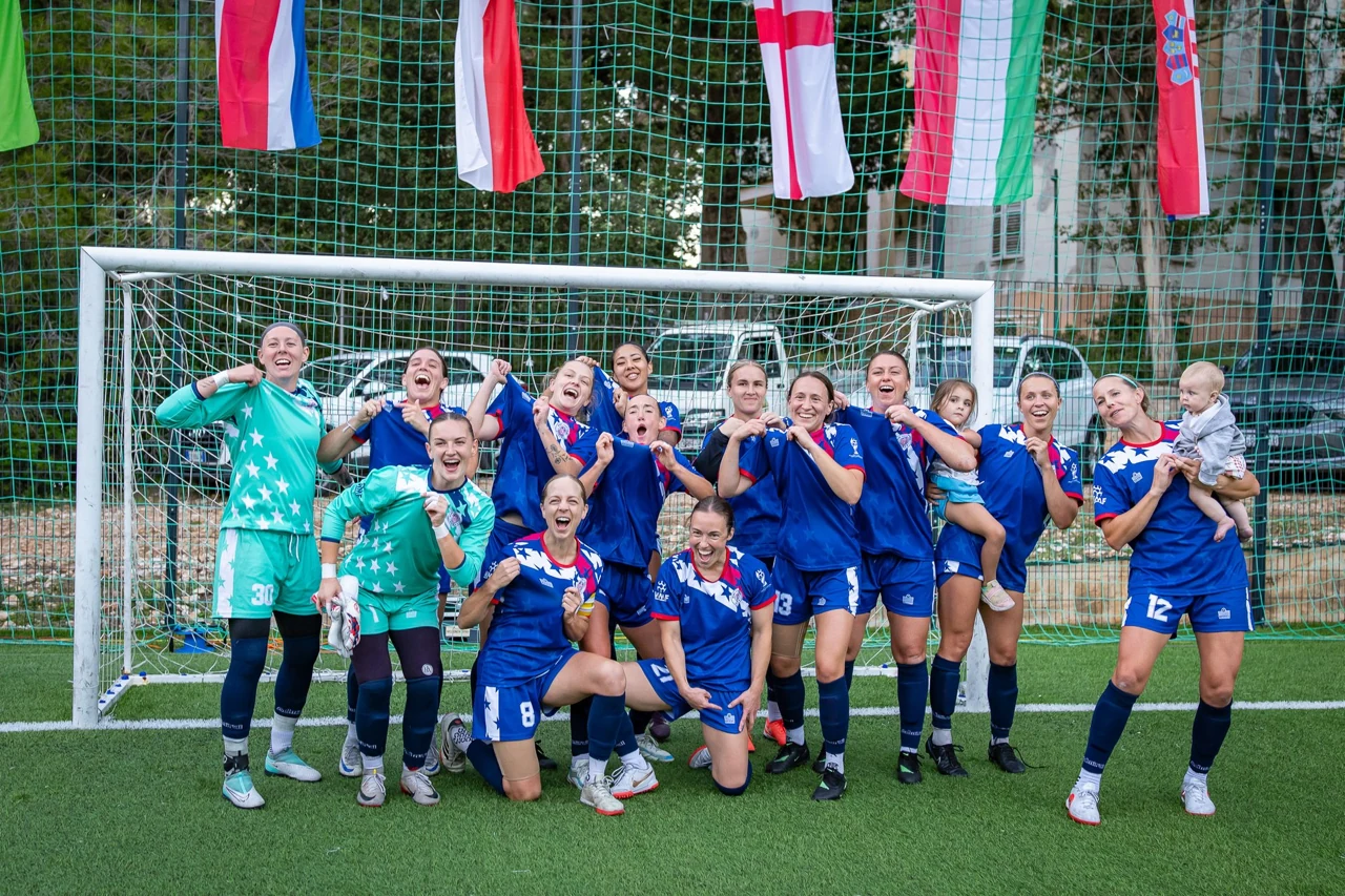 Mini Football USA players and families celebrate together in front of the goal